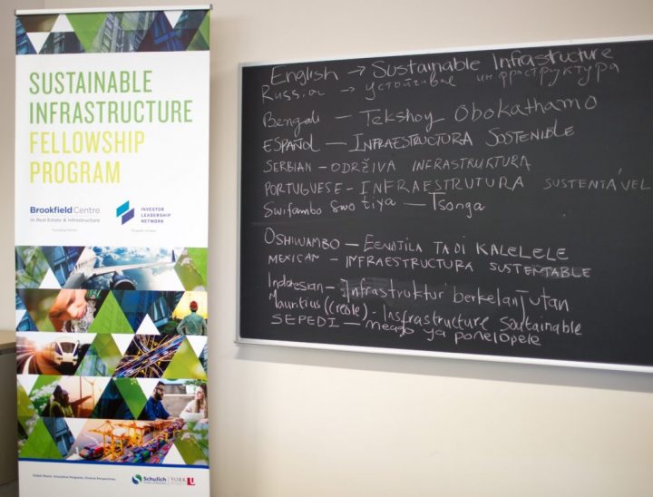 Portrait of chalkboard writing: Sustainable Infrastructure Fellowship Program in multiple languages.